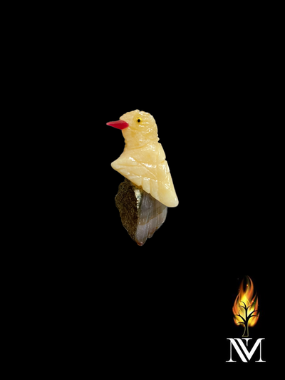 mini-yellow-bird-with-a-red-beak-on-a-black-rock